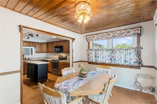 dining room with light wood-type flooring, sink, and wooden ceiling