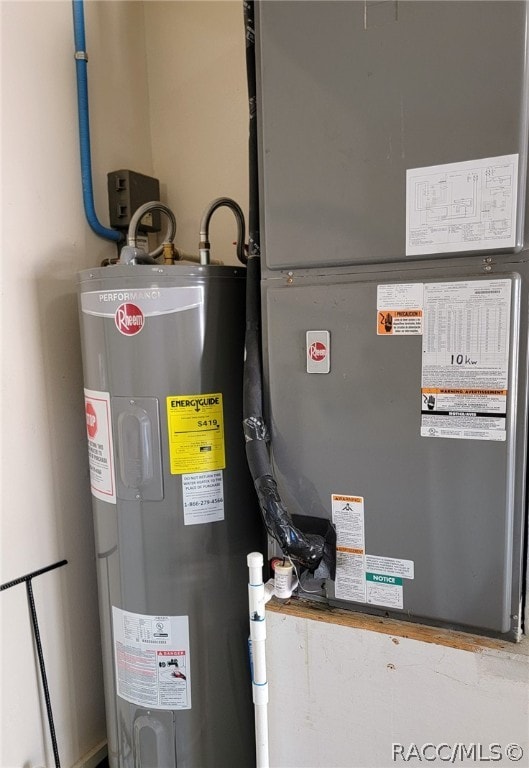 utility room featuring heating unit and water heater