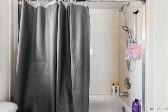 bathroom with toilet and shower / bathtub combination with curtain