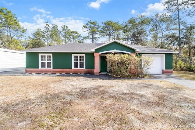 ranch-style home featuring a garage