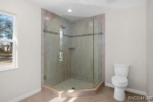 bathroom with toilet and walk in shower