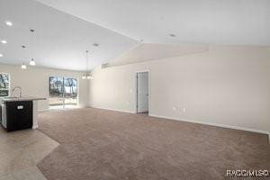 unfurnished living room featuring lofted ceiling and dark colored carpet