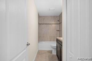 full bathroom featuring tiled shower / bath, vanity, and toilet