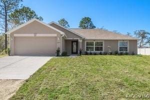 ranch-style home with a garage and a front lawn