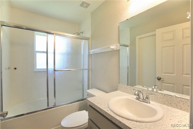 11609 SW 59th Ter, Ocala, FL 34476 - full bathroom featuring toilet, vanity, and combined bath / shower with glass door