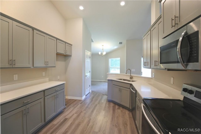 11609 SW 59th Ter, Ocala, FL 34476 - kitchen with stainless steel appliances, gray cabinetry, a sink, vaulted ceiling, and recessed lighting
