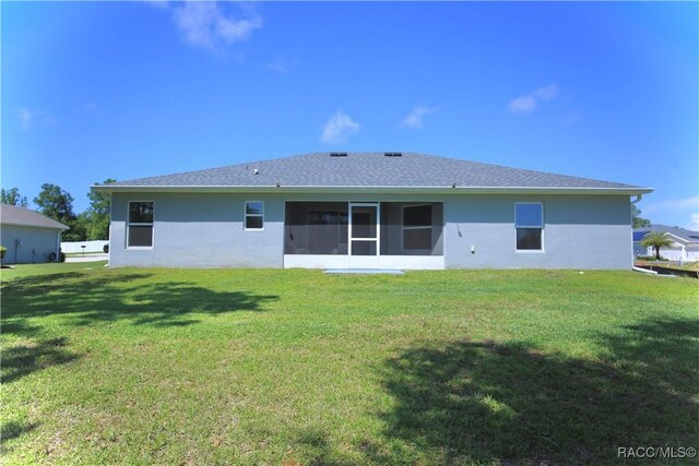 11609 SW 59th Ter, Ocala, FL 34476 - rear view of property with a yard, stucco siding, and a sunroom