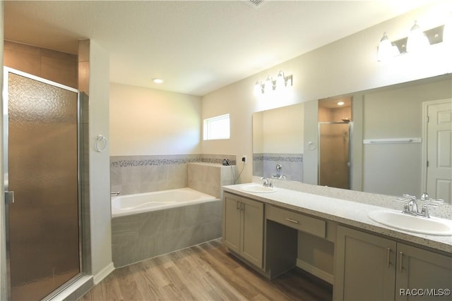 11609 SW 59th Ter, Ocala, FL 34476 - full bath featuring wood finished floors, a garden tub, a shower stall, and double vanity