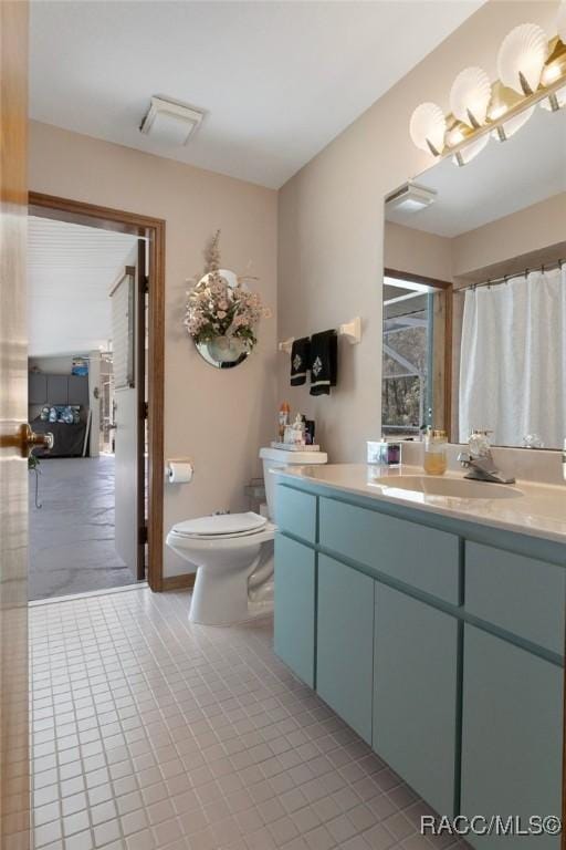 bathroom with toilet and vanity