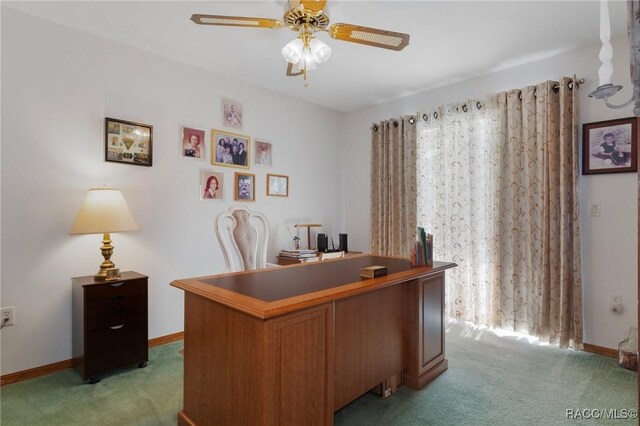 office area with light colored carpet, baseboards, and a ceiling fan