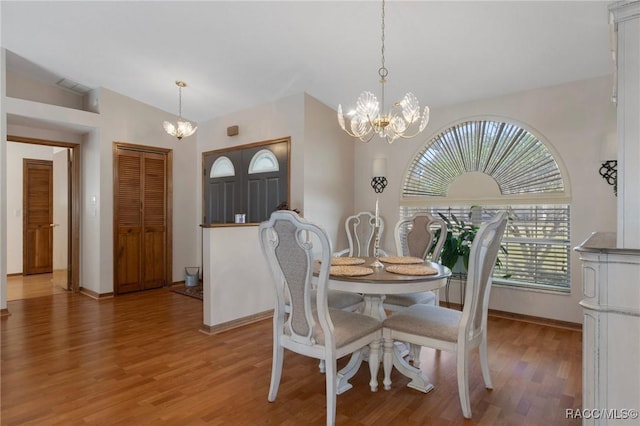 dining room with baseboards, light wood-style floors, and a chandelier