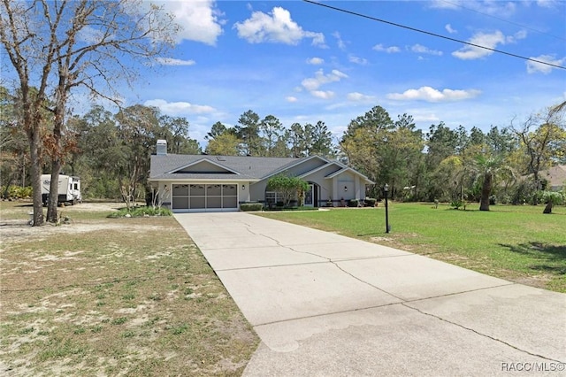 ranch-style home with a chimney, a garage, concrete driveway, and a front lawn