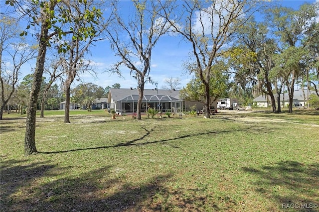 view of yard featuring glass enclosure