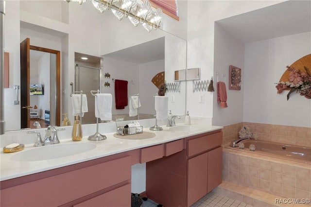 bathroom featuring tile patterned flooring, a shower stall, double vanity, and a sink