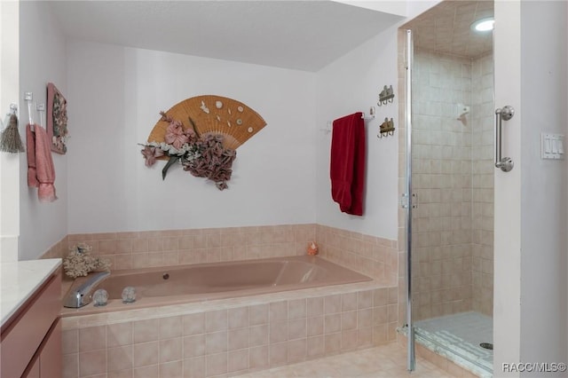 bathroom featuring a bath, a shower stall, and vanity