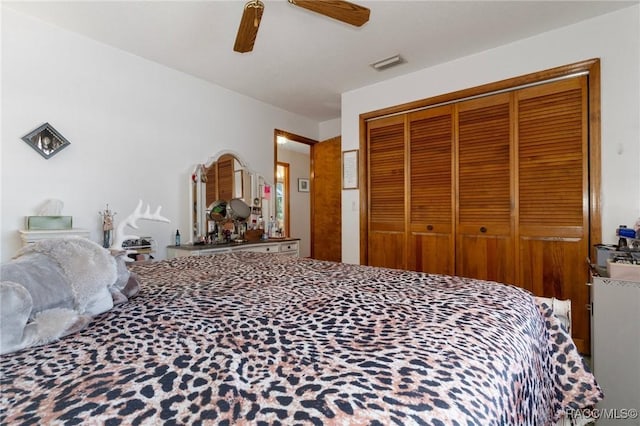 bedroom featuring a closet, visible vents, and ceiling fan