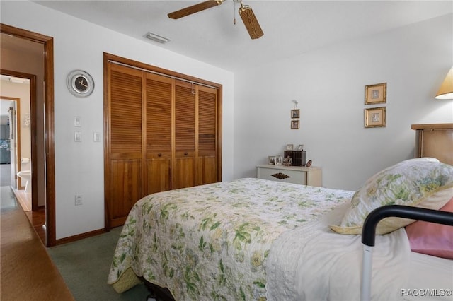 carpeted bedroom with baseboards, visible vents, a closet, and ceiling fan