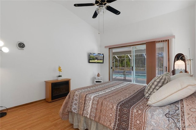 bedroom with a ceiling fan, baseboards, light wood finished floors, lofted ceiling, and access to exterior