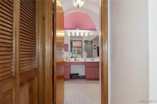 full bath featuring a shower with shower door, a chandelier, vanity, and tile patterned flooring