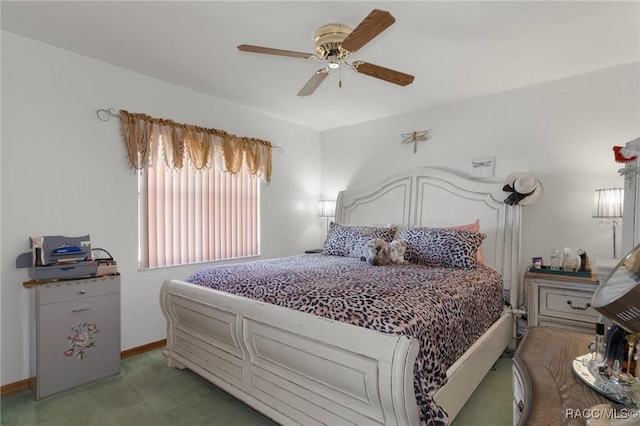 bedroom with a ceiling fan, baseboards, and light carpet