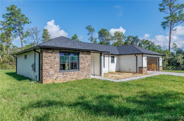 5898 N Flagstaff Ave, Beverly Hills, FL 34465 - ranch-style house with stone siding, a front lawn, a garage, concrete driveway, and a shingled roof