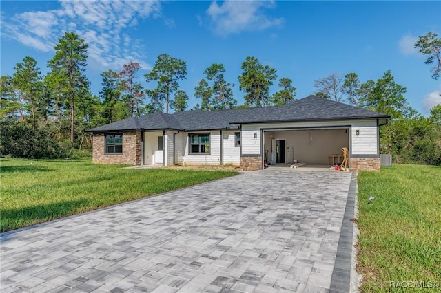 5898 N Flagstaff Ave, Beverly Hills, FL 34465 - ranch-style house with decorative driveway, a front lawn, an attached garage, and stone siding