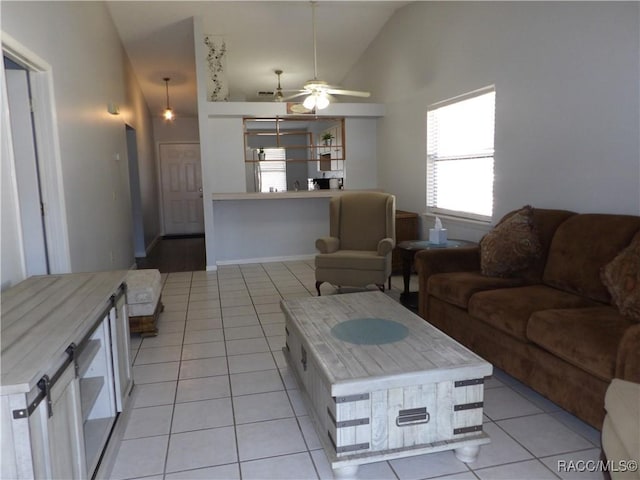 living area featuring light tile patterned floors, high vaulted ceiling, and a ceiling fan