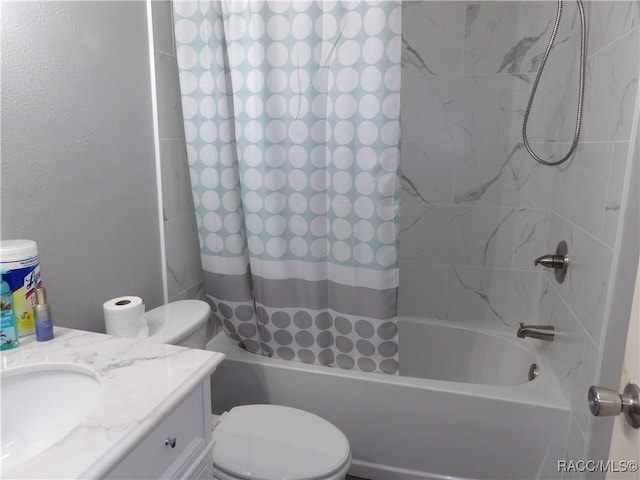 full bathroom featuring toilet, a textured wall, shower / tub combo with curtain, and vanity