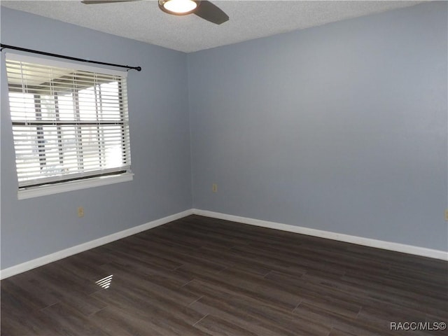 unfurnished room with a ceiling fan, a textured ceiling, baseboards, and dark wood-type flooring