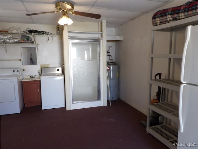 laundry area with cabinet space, water heater, a ceiling fan, and independent washer and dryer