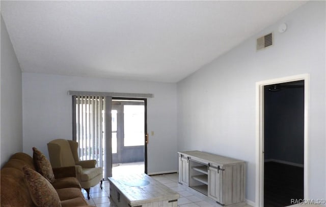 living room with lofted ceiling, light tile patterned floors, and visible vents