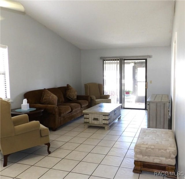 living room with vaulted ceiling and light tile patterned floors