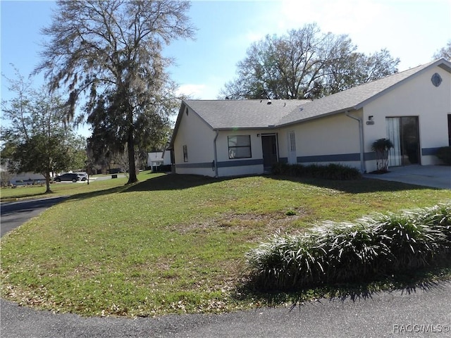 view of front of property with a front lawn and stucco siding