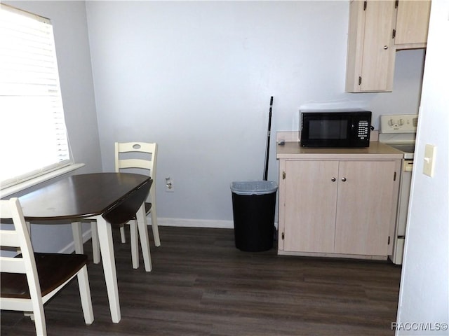 kitchen featuring dark wood-style floors, white electric range oven, light countertops, light brown cabinets, and black microwave