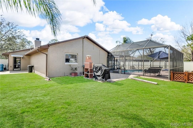 rear view of house featuring a fenced in pool, a patio, a yard, and glass enclosure