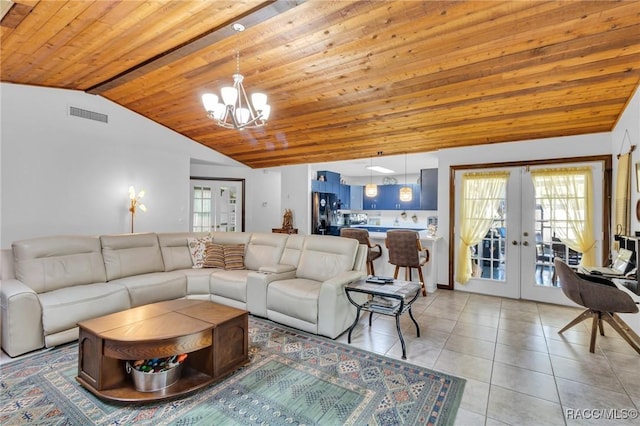 tiled living room featuring lofted ceiling, wood ceiling, french doors, and a chandelier