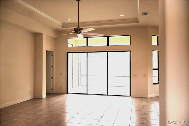 1366 N Bellamy Pt, Hernando, FL 34442 - spare room with visible vents, a high ceiling, a tray ceiling, a ceiling fan, and light tile patterned floors