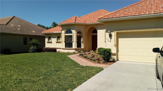 1366 N Bellamy Pt, Hernando, FL 34442 - view of front of property featuring a tiled roof, driveway, a front yard, an attached garage, and stucco siding