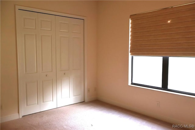 1366 N Bellamy Pt, Hernando, FL 34442 - unfurnished bedroom with a closet, baseboards, and light carpet
