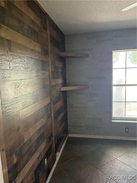 unfurnished room with a textured ceiling