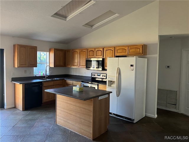 kitchen featuring stainless steel appliances, a kitchen island, lofted ceiling, and sink