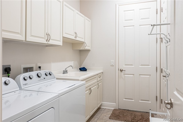 laundry area featuring cabinets, sink, light tile patterned floors, and washer and dryer