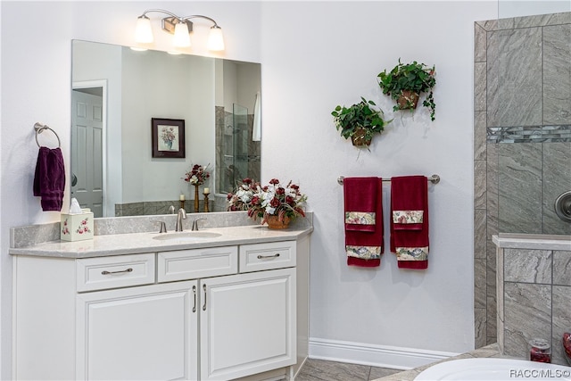 bathroom featuring tiled shower, vanity, and tile patterned floors