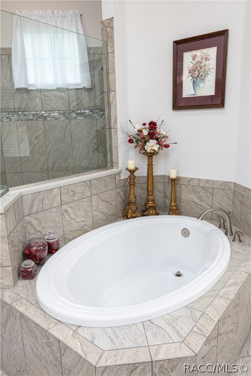 bathroom with shower with separate bathtub