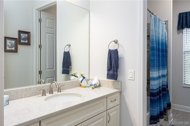 bathroom with tile patterned floors, vanity, and walk in shower