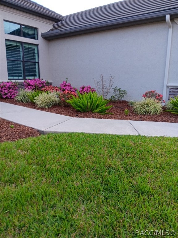 view of property exterior featuring a yard