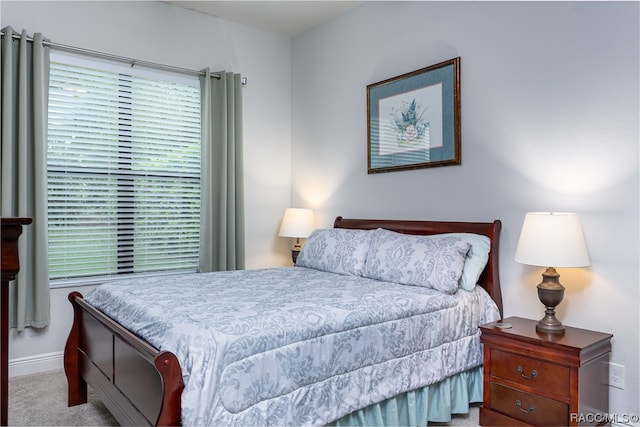 bedroom featuring light carpet