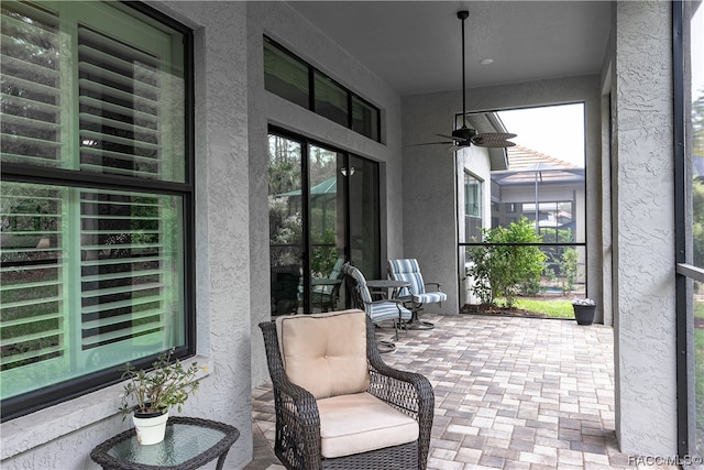 sunroom featuring ceiling fan