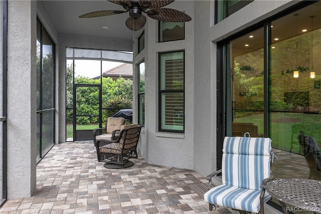 sunroom featuring ceiling fan