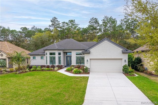 view of front facade with a garage and a front lawn